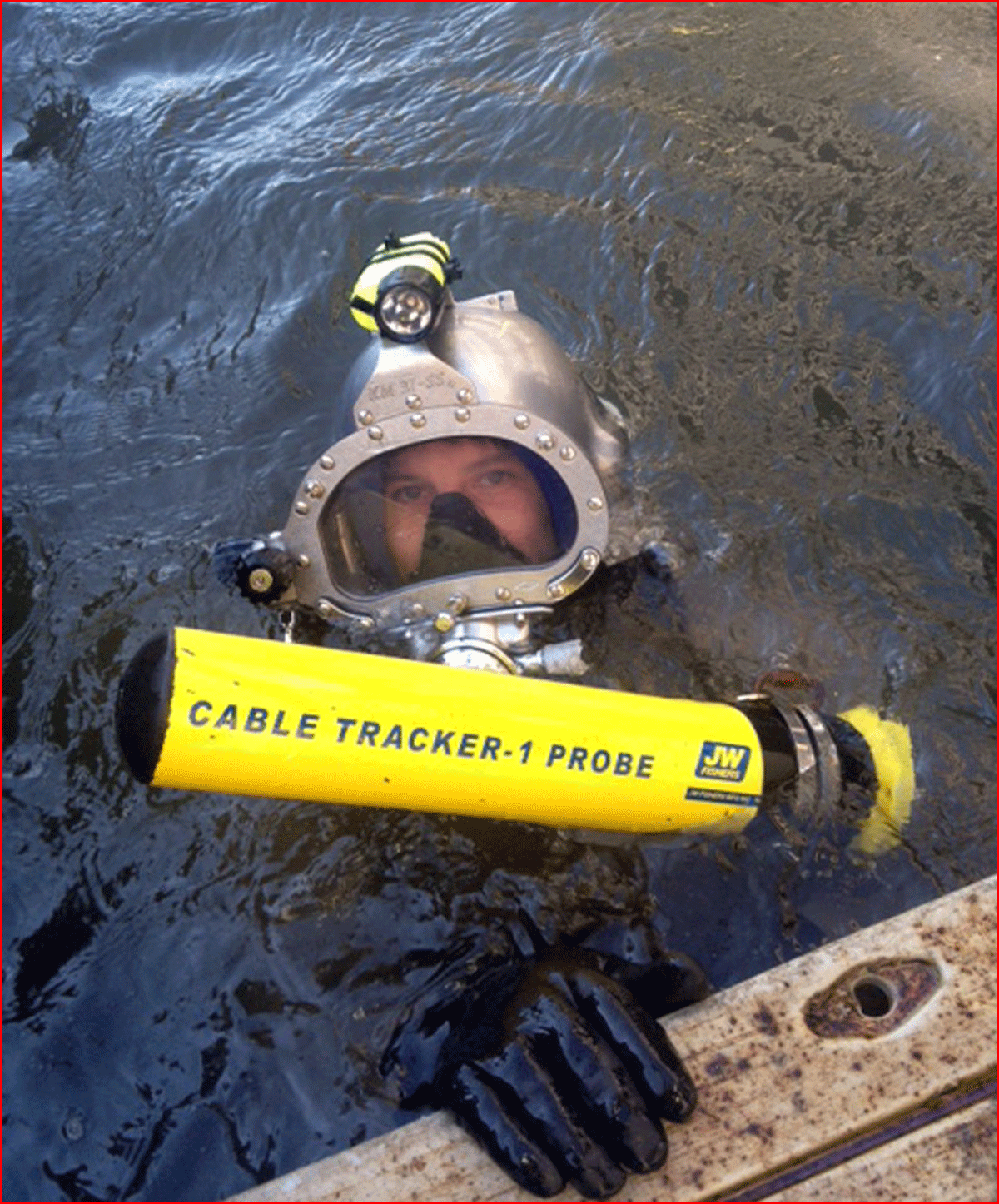 One person in surface of water holding Cable Tracker-1 Probe