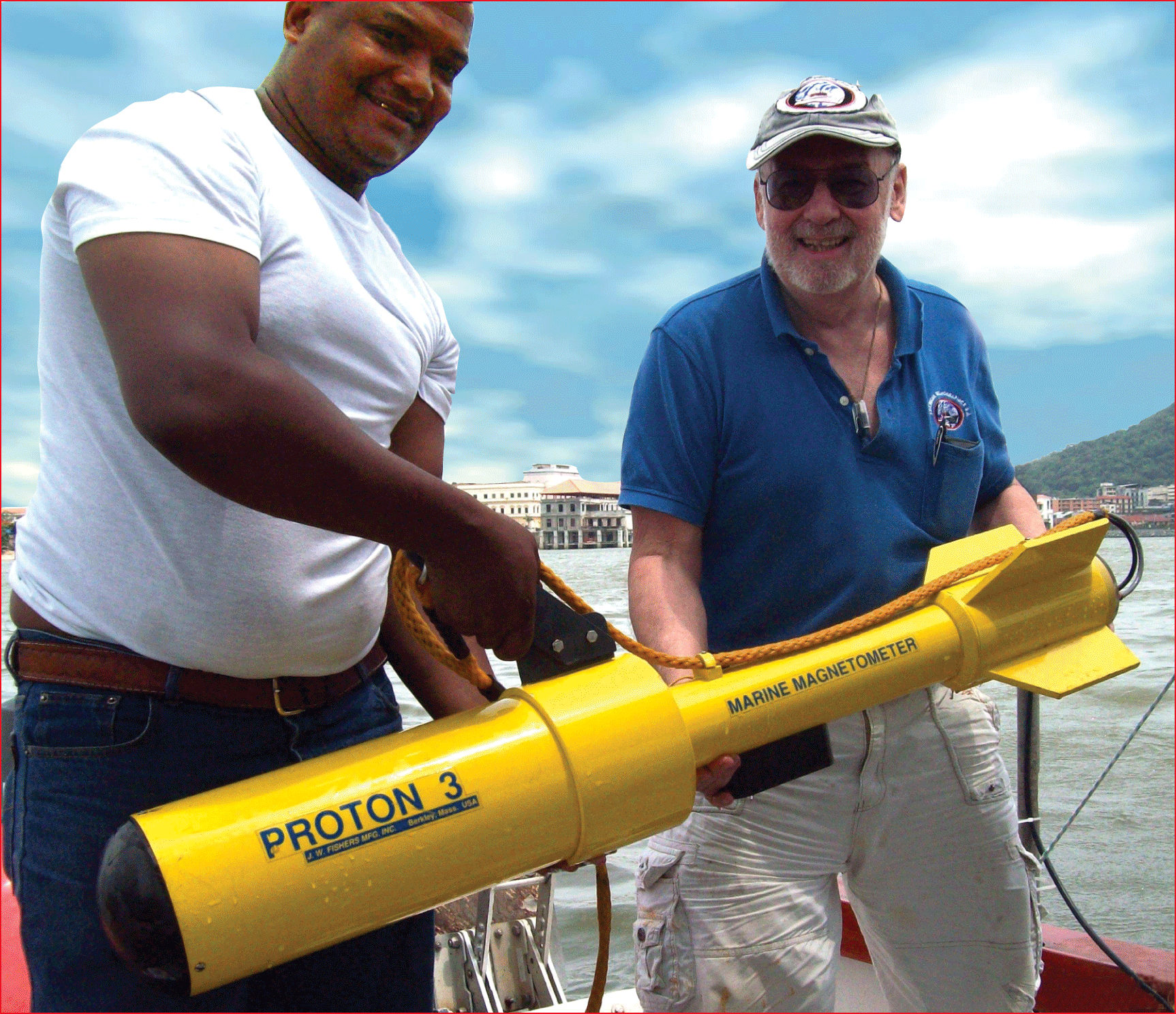 Two man holding a Proton 3 - Marine Magnetometer